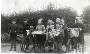 Photograph of children delivering harvest festival goods, c1930's